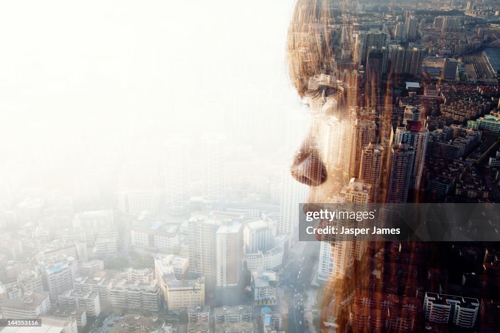 Double exposure of woman and cityscape