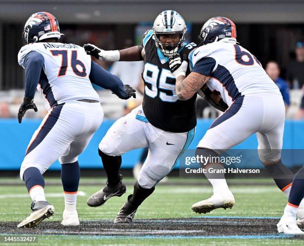 Derrick Brown of the Carolina Panthers rushes against Dalton Risner of the Denver Broncos during their game at Bank of America Stadium on November...