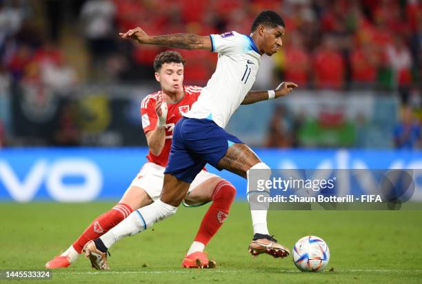 Marcus Rashford of England controls the ball under pressure of Neco Williams of Wales during the FIFA World Cup Qatar 2022 Group B match between...