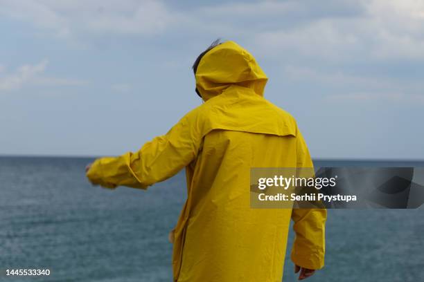 seaman in raincoat - raincoat stockfoto's en -beelden