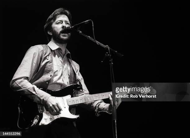 Eric Clapton performs on stage at Ahoy, Rotterdam, Netherlands, 23rd April 1983. He plays a Fender Stratocaster guitar.