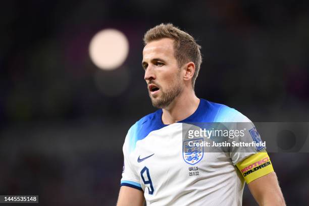 Harry Kane of England looks on wearing a 'Protect Children' captains armband during the FIFA World Cup Qatar 2022 Group B match between Wales and...