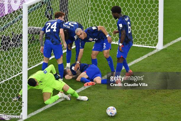 Christian Pulisic of United States is attended to after scoring their team's first goal past Alireza Beiranvand of IR Iran during the FIFA World Cup...