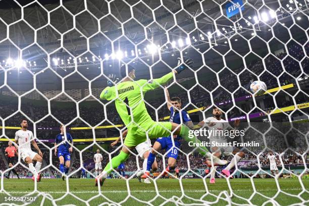 Christian Pulisic of United States scores their team's first goal past Alireza Beiranvand of IR Iran during the FIFA World Cup Qatar 2022 Group B...