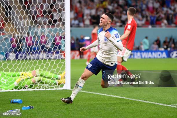 Phil Foden of England celebrates after scoring their team's second goal during the FIFA World Cup Qatar 2022 Group B match between Wales and England...