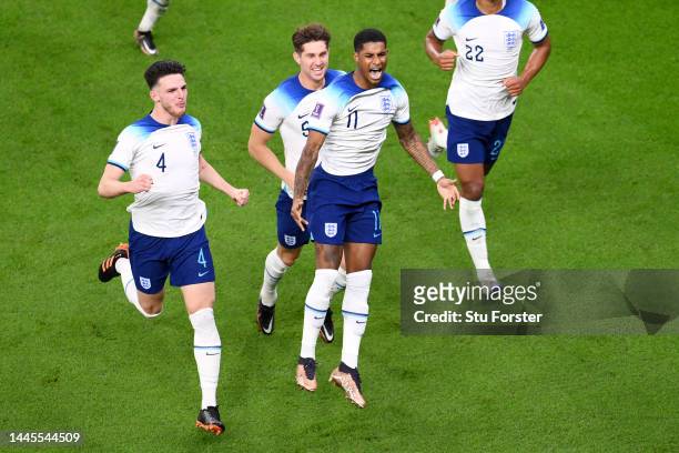 Marcus Rashford of England celebrates with teammates after scoring their team's first goal during the FIFA World Cup Qatar 2022 Group B match between...
