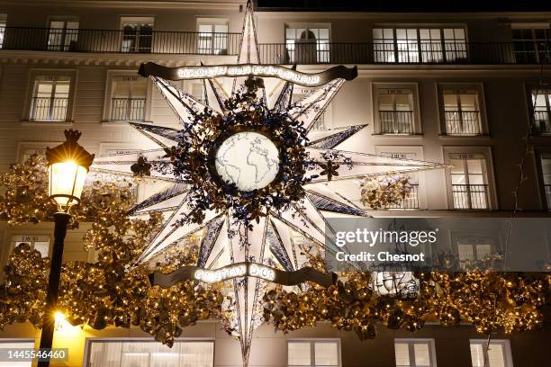 An illuminated star is displayed on the facade of the illuminated and decorated Dior boutique for the Christmas and New Year celebrations on November...