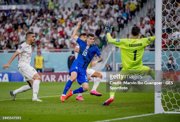 Christian Pulisic of USA scores his team's first goal past Majid Hosseini , Alireza Beiranvand and Amir Abedzadeh of Iran during the FIFA World Cup...