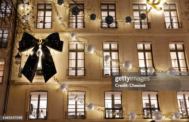 Giant black lavaliere is displayed on the facade of the illuminated and decorated Chanel boutique for the Christmas and New Year celebrations on...