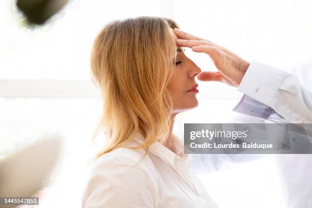 male therapist using hypnosis therapy on woman - hypnosis woman stock pictures, royalty-free photos & images