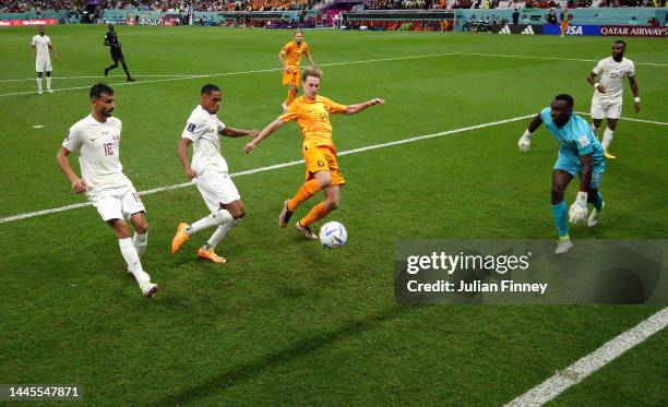 Frenkie de Jong of Netherlands scores their team's second goal past Pedro Miguel of Qatar during the FIFA World Cup Qatar 2022 Group A match between...