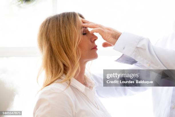 male therapist using hypnosis therapy on woman - hypnosis stock pictures, royalty-free photos & images