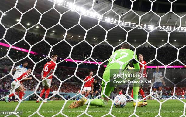 Marcus Rashford of England scores their team's third goal past Danny Ward of Wales during the FIFA World Cup Qatar 2022 Group B match between Wales...
