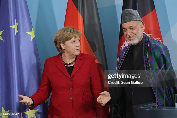 German Chancellor Angela Merkel and Afghan President Hamid Karzai depart after speaking to the media after signing agreements on the future role of...