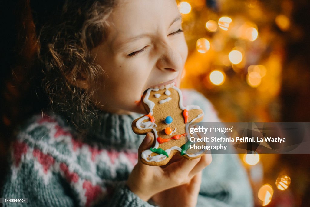 Child Biting Hard a Gingerbread Cookie