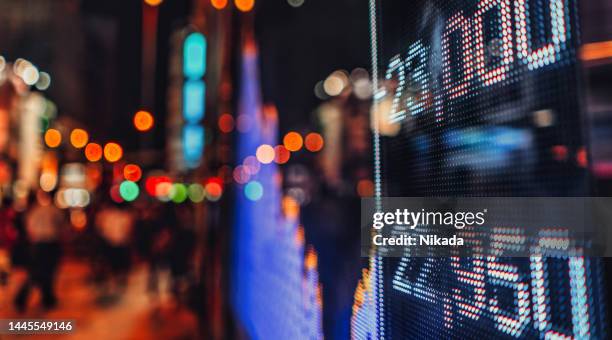 affichage des cotations boursières avec la scène de la ville réfléchir sur le verre - financial market photos et images de collection