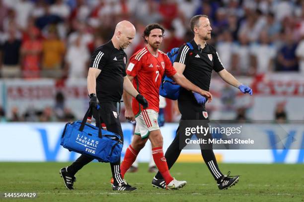 Joe Allen of Wales walks off the pitch with medical staffs as he is substituted during the FIFA World Cup Qatar 2022 Group B match between Wales and...