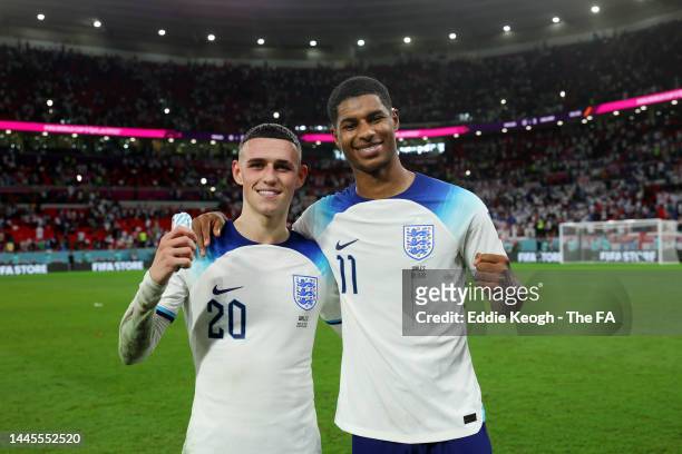 Phil Foden and Marcus Rashford of England celebrate following the FIFA World Cup Qatar 2022 Group B match between Wales and England at Ahmad Bin Ali...