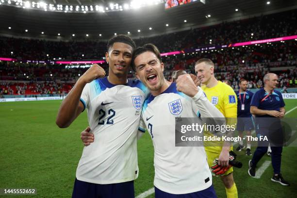 Jude Bellingham and Jack Grealish of England celebrate following the FIFA World Cup Qatar 2022 Group B match between Wales and England at Ahmad Bin...