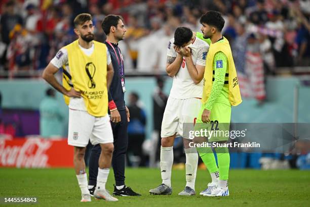 Amir Abedzadeh and Saeid Ezatolahi of IR Iran react after the 0-1 loss during the FIFA World Cup Qatar 2022 Group B match between IR Iran and USA at...