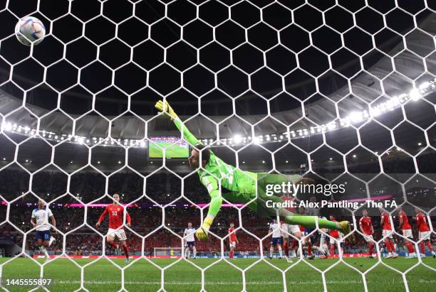 Danny Ward of Wales fails to stop England's first goal, a free kick from Marcus Rashford of England during the FIFA World Cup Qatar 2022 Group B...