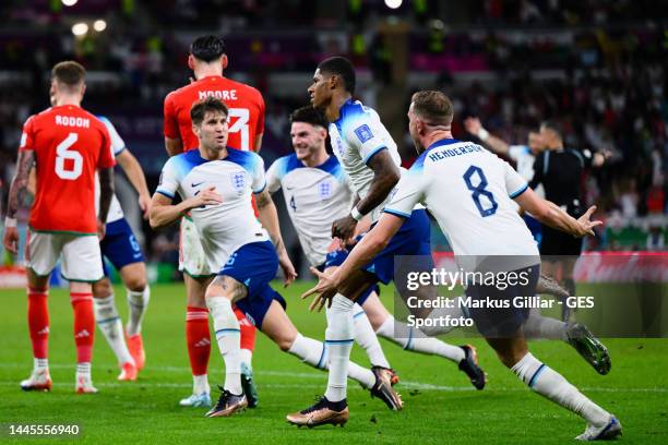 Marcus Rashford of England celebrates after scoring his team's first goal during the FIFA World Cup Qatar 2022 Group B match between Wales and...