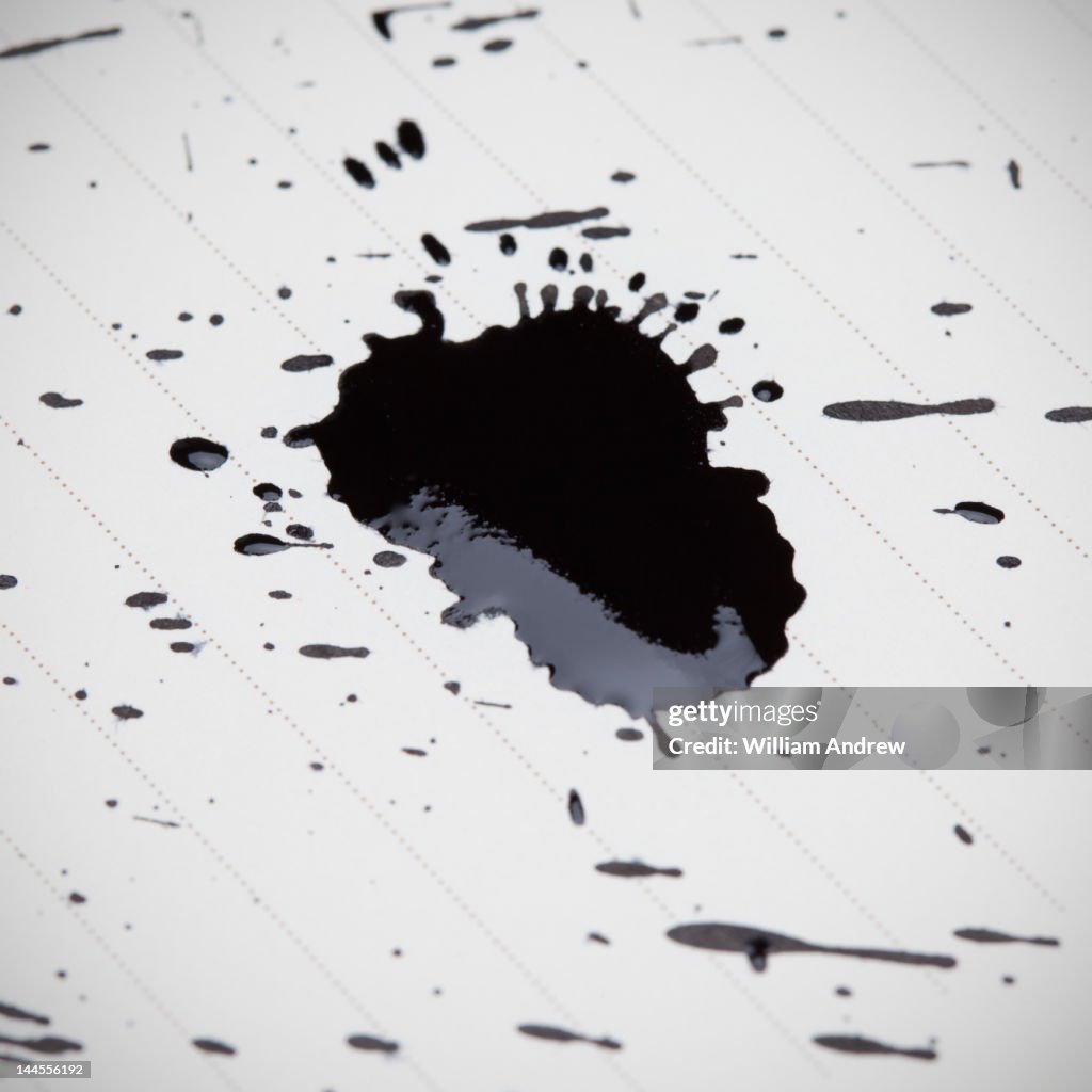 Black ink splatter on note lined paper