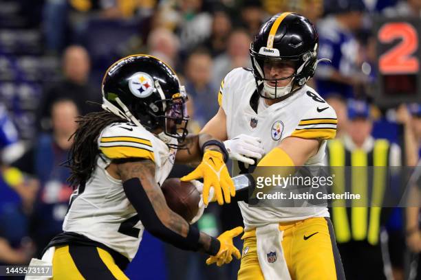 Kenny Pickett of the Pittsburgh Steelers hands the ball off to Anthony McFarland Jr. #26 in the game against the Indianapolis Colts at Lucas Oil...
