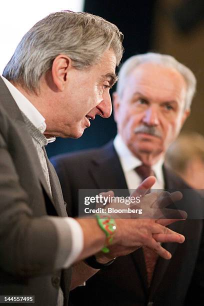 Nick Hayek, chief executive officer of Swatch Group AG, left, talks with Jean-Pierre Roth, former president of the Swiss National Bank , ahead of the...