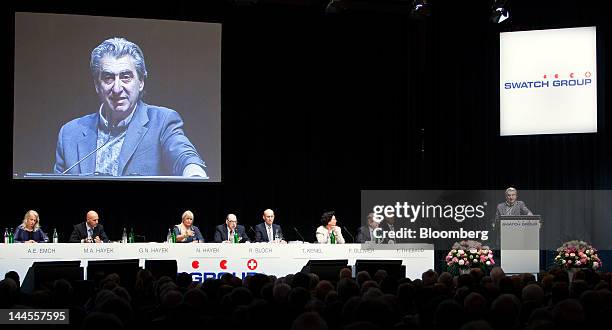 Members of the Swatch Group AG board listen as Nick Hayek, chief executive officer of Swatch Group AG, right, addresses shareholders during the...