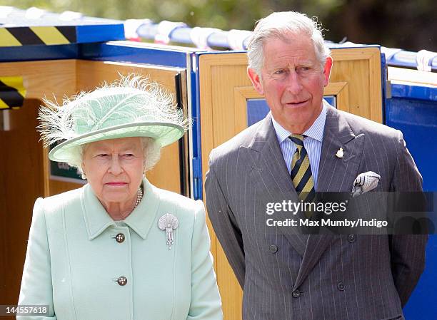 Queen Elizabeth II and Prince Charles, Prince of Wales travel down the Leeds and Liverpool Canal on the 'Pride of Sefton' barge on day 1 of a visit...