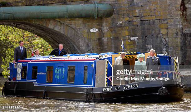 Prince Philip, Duke of Edinburgh, Queen Elizabeth II and Prince Charles, Prince of Wales travel down the Leeds and Liverpool Canal on the 'Pride of...