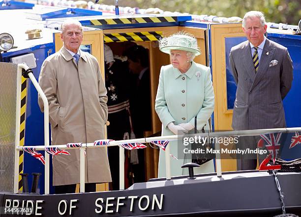 Prince Philip, Duke of Edinburgh, Queen Elizabeth II and Prince Charles, Prince of Wales travel down the Leeds and Liverpool Canal on the 'Pride of...