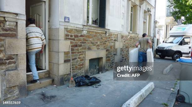 Movers empty the house of the Dupont de Ligonnes family on May 16, 2012 in the western city of Nantes. The mother and the four children were murdered...