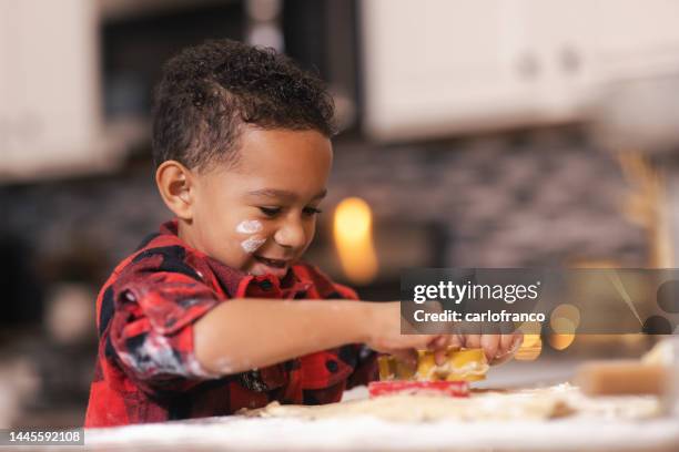 four year old making holiday cookies - christmas - african american black - cookie cutter - rolling pin stock pictures, royalty-free photos & images