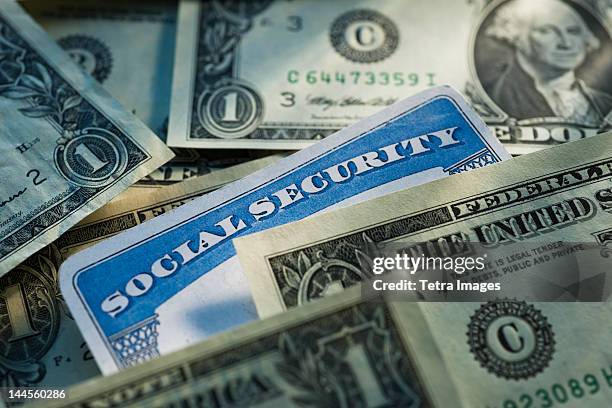 studio shot of social security card and banknotes - sozialversicherung stock-fotos und bilder