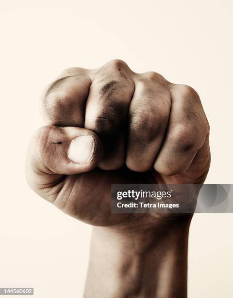 close-up of fist, studio shot - fist stock pictures, royalty-free photos & images