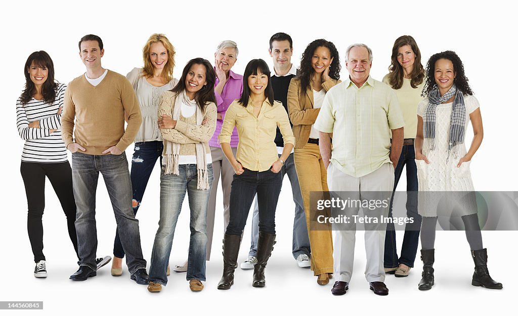 Studio portrait of large group of people standing arm in arm
