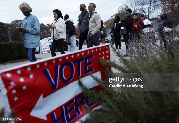 Residents wait in line to vote early outside a polling station on November 29, 2022 in Atlanta, Georgia. Early voting has started in select Georgia...