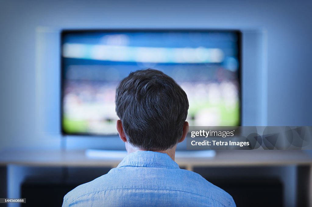 Jersey City, New Jersey, Man watching tv in living room