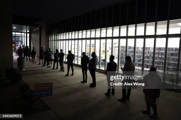 Residents wait in line to vote early outside a polling station on November 29, 2022 in Atlanta, Georgia. Early voting has started in select Georgia...