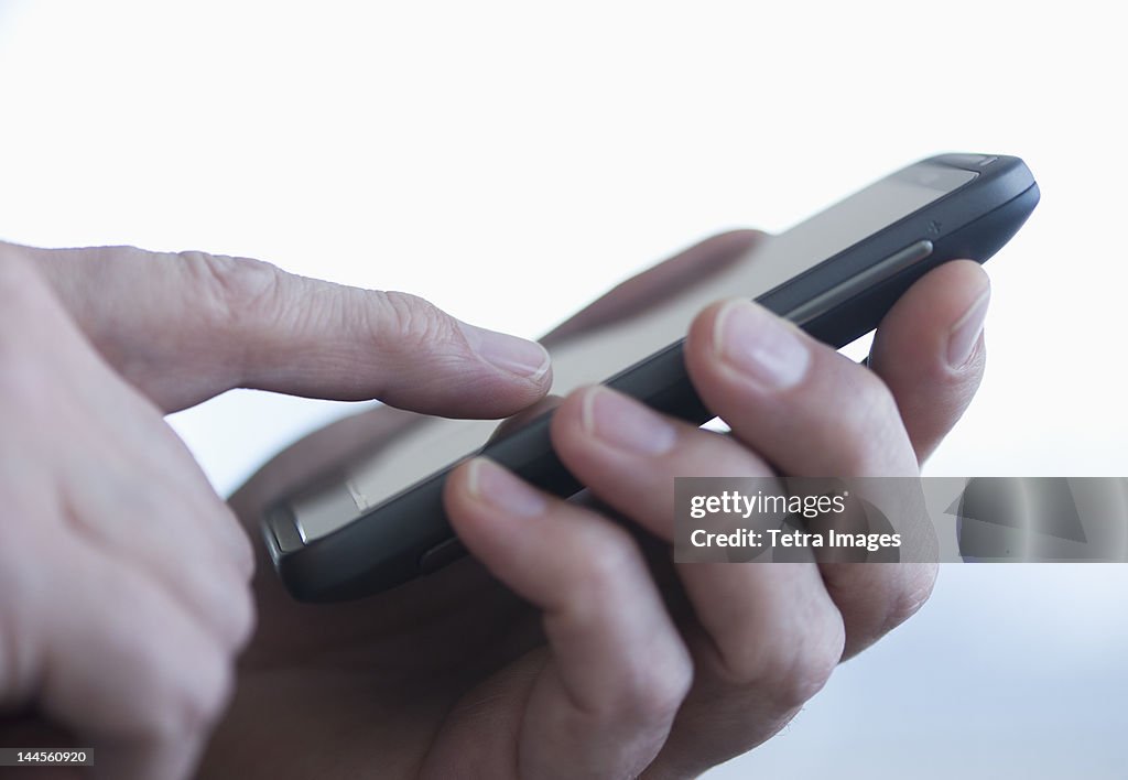 Jersey City, New Jersey, Close up of businessman's hands holding PDA