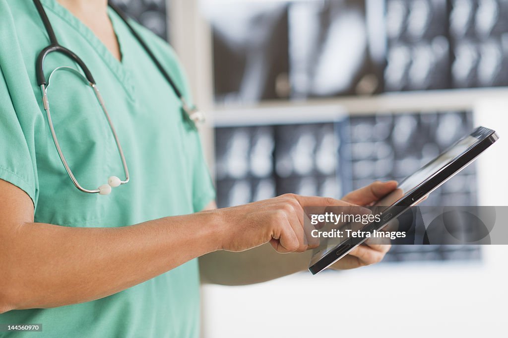 USA, New Jersey, Jersey City,  Close up of male doctor using digital tablet