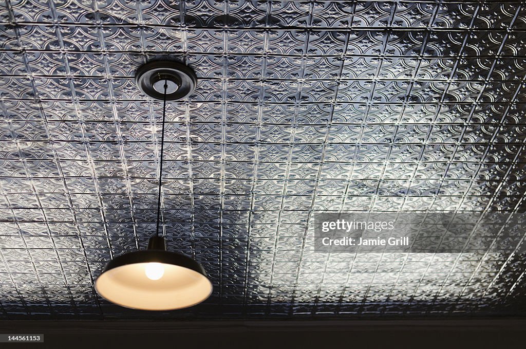 USA, New York State, New York City, Brooklyn, Pendant lamp on tiled ceiling