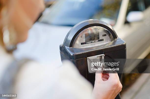 usa, new york state, new york city, brooklyn, woman inserting coin into parking meter - パーキングメーター ストックフォトと画像