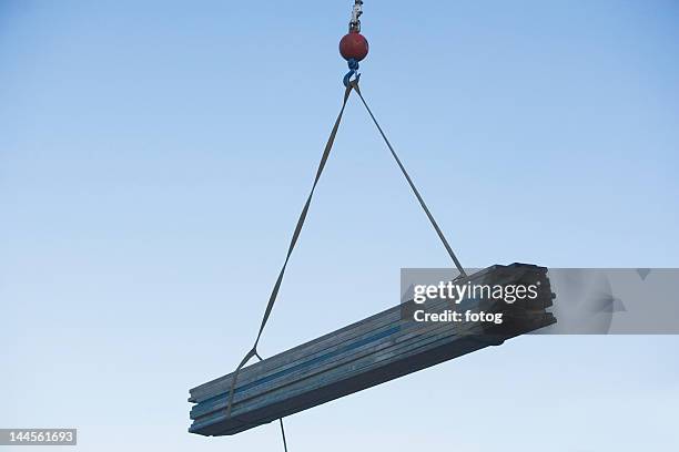 usa, pennsylvania, philadelphia, mid-air view at crane's hook lifting wooden planks - crane hook stock-fotos und bilder