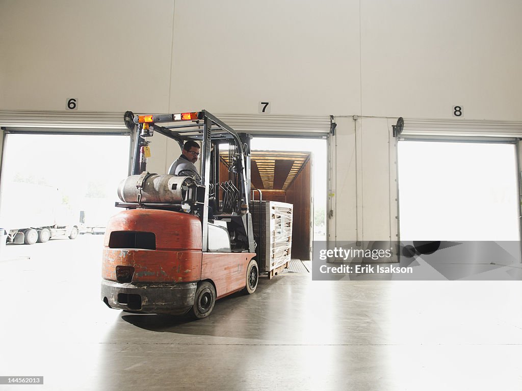 USA, California, Santa Ana, Forklift driver working in warehouse