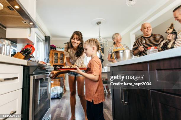 family together in the kitchen - multi generational family with pet stock pictures, royalty-free photos & images