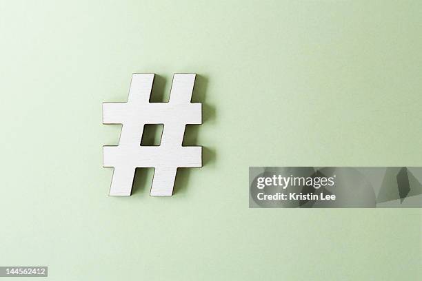 hashtag on white background, studio shot - hashtag foto e immagini stock