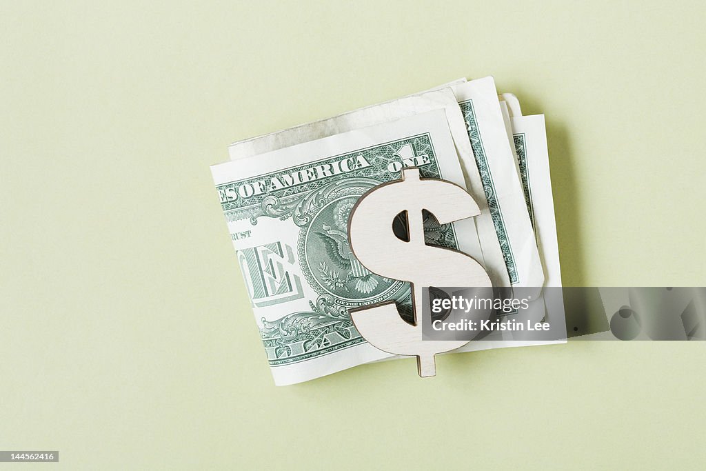 Dollar banknotes in dollar symbol shaped money clip, studio shot